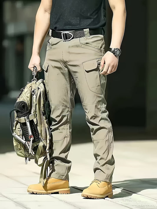 Person wearing camouflage pants and tan boots holding a backpack. Biggreenbear.com