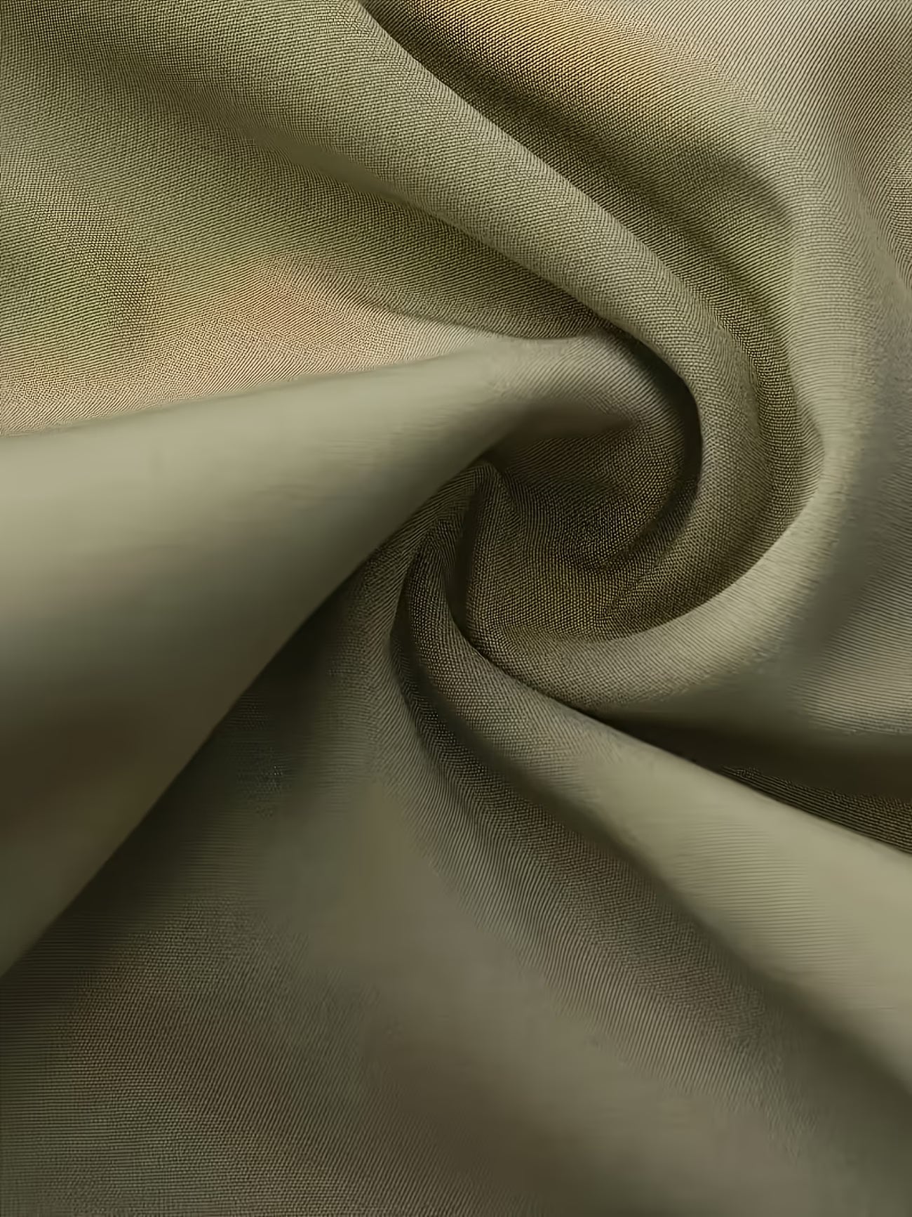 Close-up of olive green fabric with folds