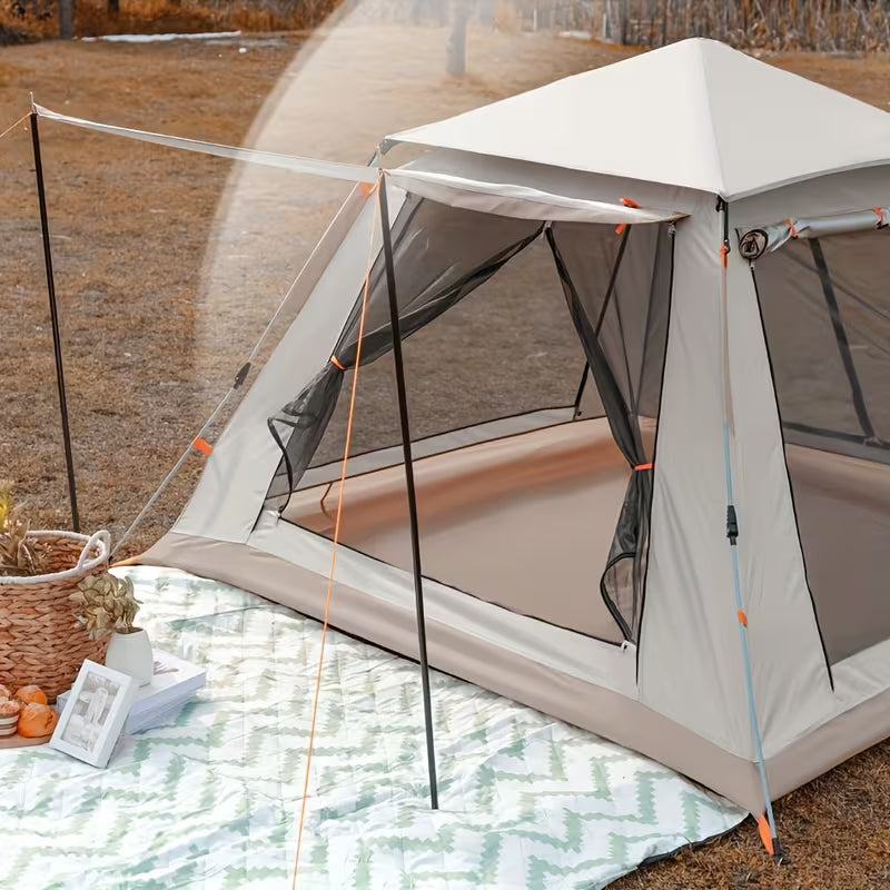 Camping tent with a small table and basket on a grassy area