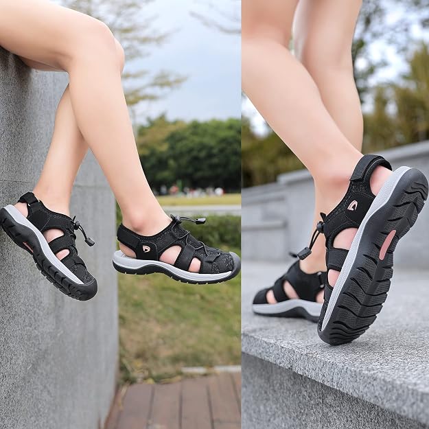 A side-by-side comparison of a woman wearing black outdoor sandals with different angles: one showing the feet dangling against a gray wall, and the other showing the sole and side profile on concrete steps outdoors.
