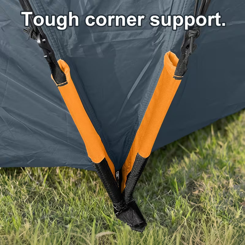 Tent corner support system with orange straps and black hardware on grass.