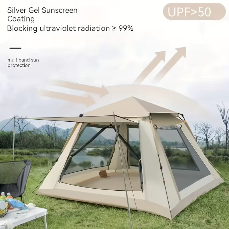 Beige camping tent with silver gel sunscreen coating on a grassy area with a lake and mountains in the background.