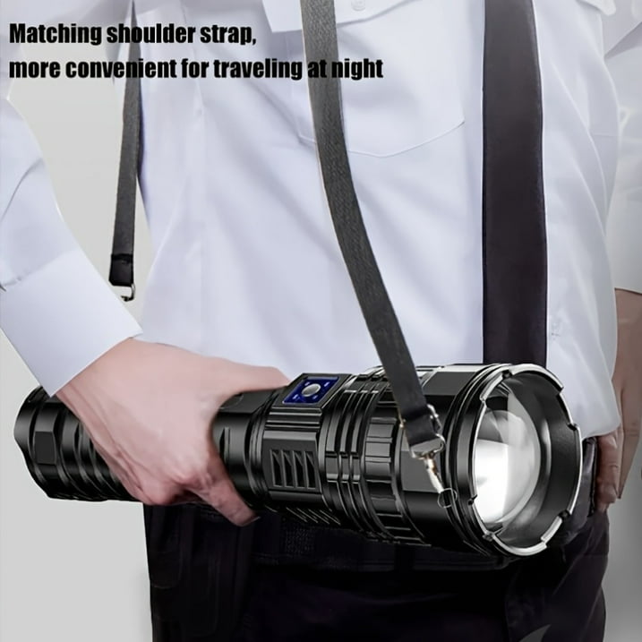 Person holding a flashlight with a matching shoulder strap, suitable for travel at night.