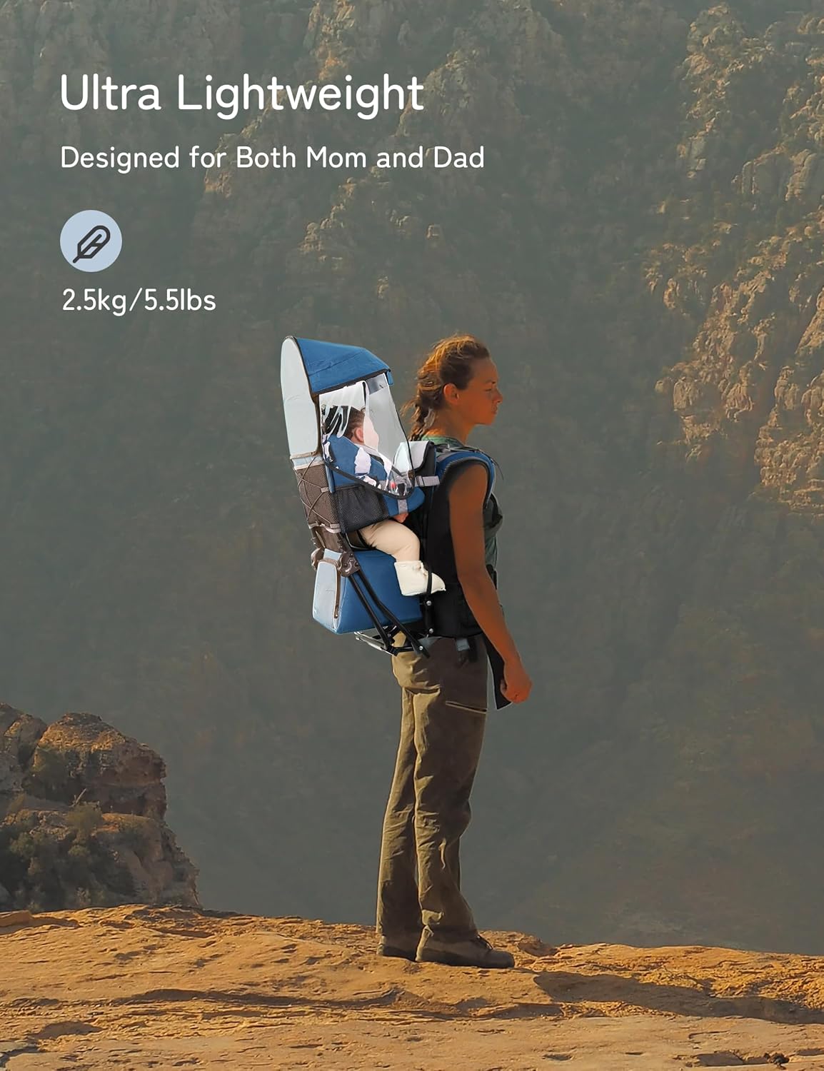 A woman hiking outdoors on a rocky mountain trail wearing a blue and white Ultra Lightweight baby carrier with a baby inside. Text overlays on the top left read 'Ultra Lightweight', 'Designed for Both Mom and Dad', and '2.