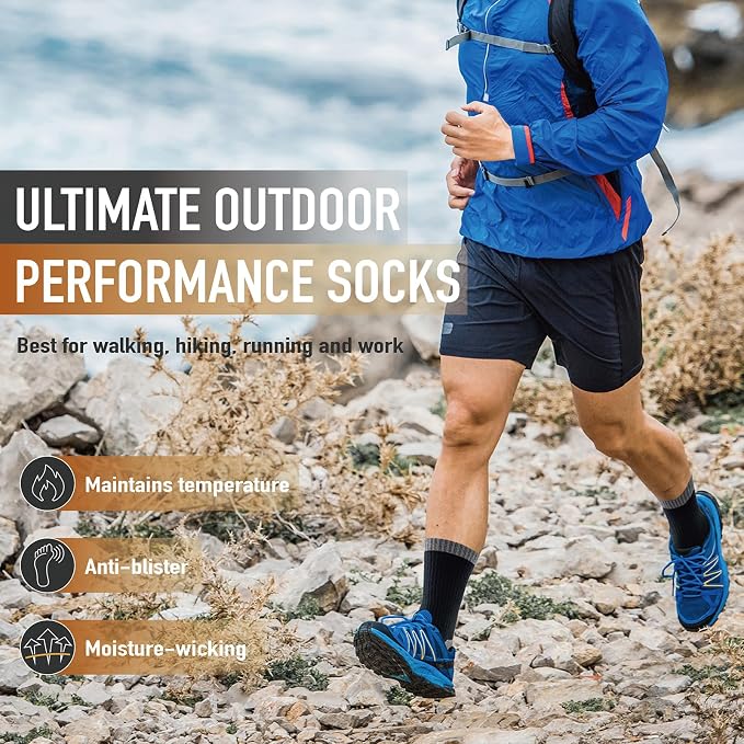 A person outdoors on a rocky path wearing blue running socks with black and blue athletic shoes, a blue jacket, and black shorts. Large text reads 'ULTIMATE OUTDOOR PERFORMANCE SOCKS' with feature callouts about maintaining temperature, anti-blister, and moisture-wicking.