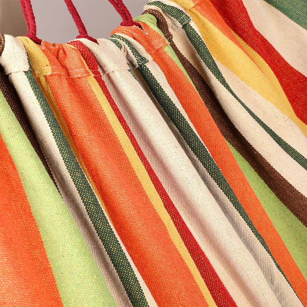 Close-up of a colorful striped hammock with red, orange, green, and white patterns.