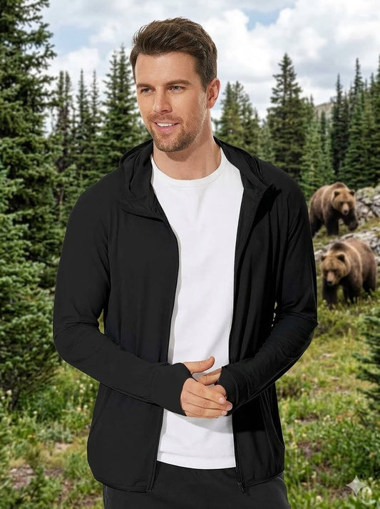Man wearing a black jacket and white shirt standing in a forest with bears in the background Big Green Bear