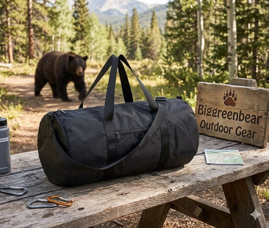 Black duffel bag on a wooden bench with a bear in the background, featuring Biggreenbear Outdoor Gear branding.