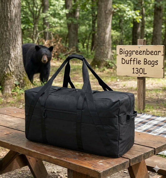 Black duffel bag on a wooden bench with a bear in the background and a sign for Biggreenbear Duffle Bags.