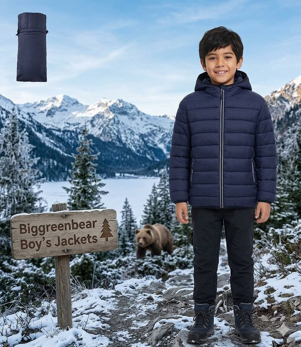 Child wearing a blue puffer jacket standing in a snowy mountain landscape with a bear and 'Biggreenbear Boy's Jackets' sign.