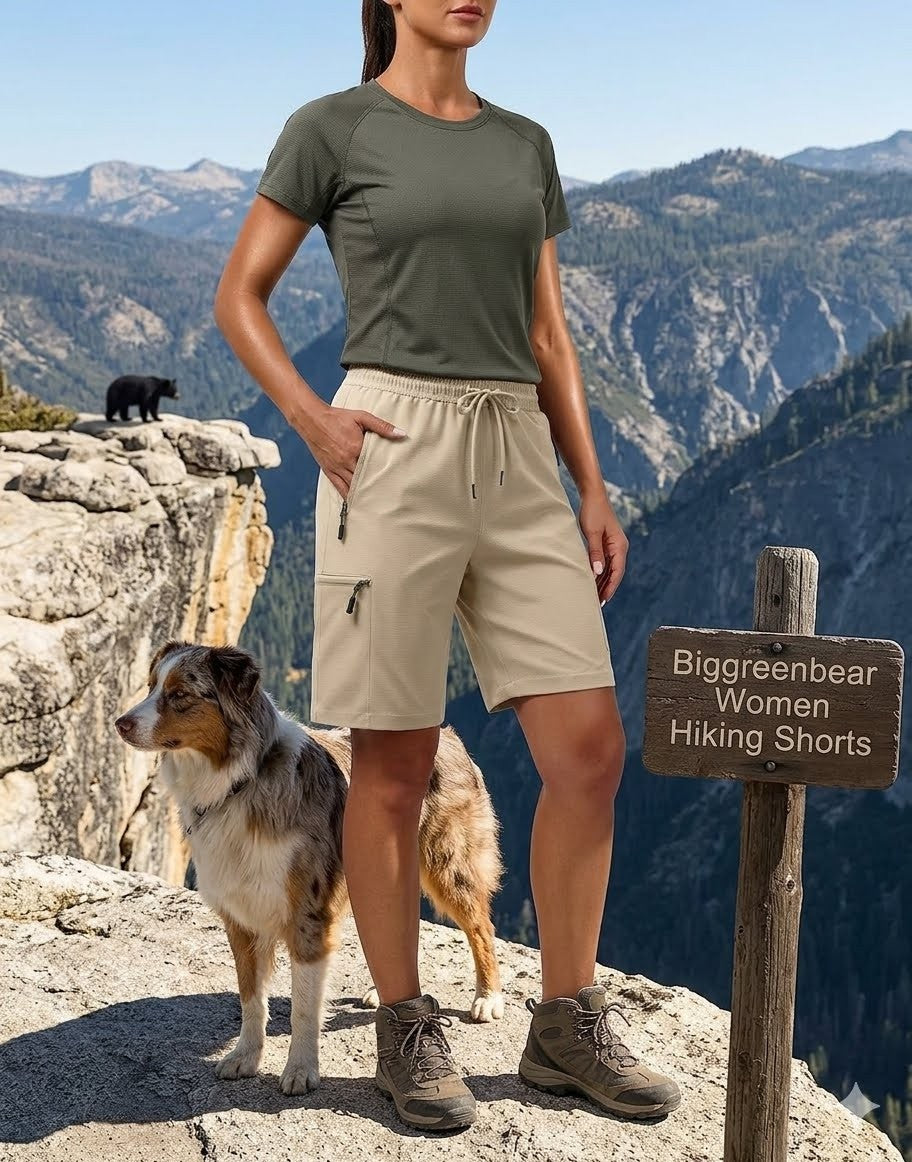 Woman in hiking attire with a dog on a mountain peak, wearing Biggreenbear Women Hiking Shorts.