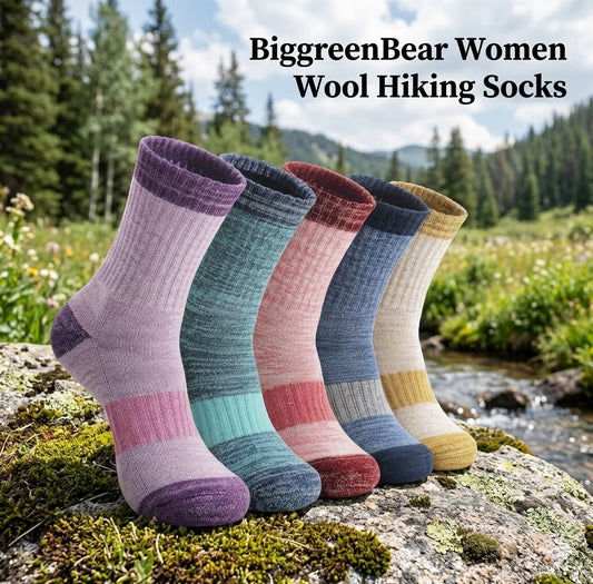 Five pairs of women's wool hiking socks in various colors on a rock with a forest background. big green bear