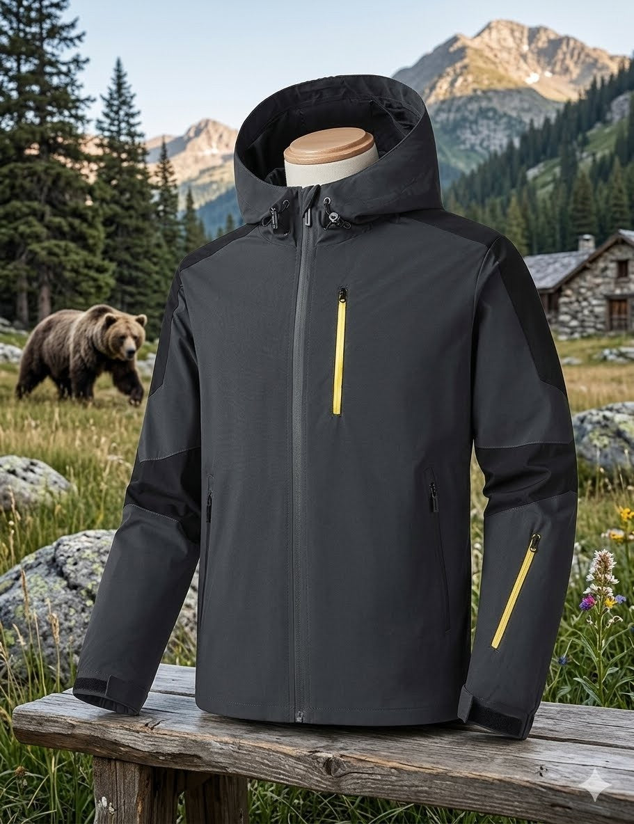 Black jacket with yellow accents on a wooden bench in a mountainous landscape with a bear and cabin. Biggreenbear.com