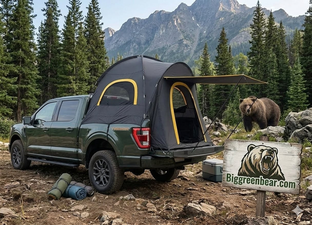 Green truck with a tent attached in a forest with a bear and 'Biggreenbear.com' sign.