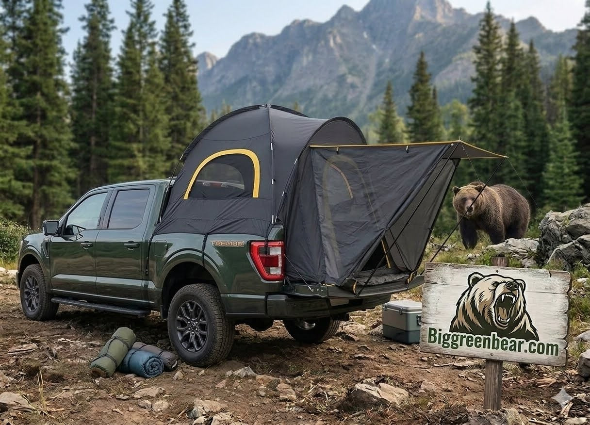 Green truck with a rooftop tent in a forest setting, featuring a bear and 'Biggreenbear.com' sign.