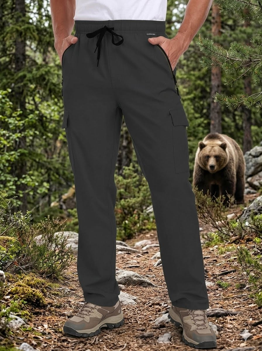 Person wearing dark gray cargo pants in a forest with a bear in the background Biggreenbear.com
