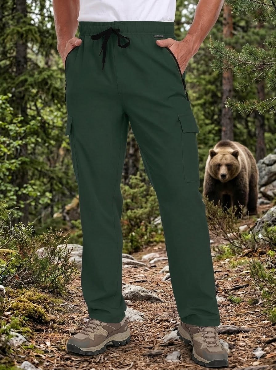 Person wearing green pants standing in a forest with a bear in the background Biggreenbear.com