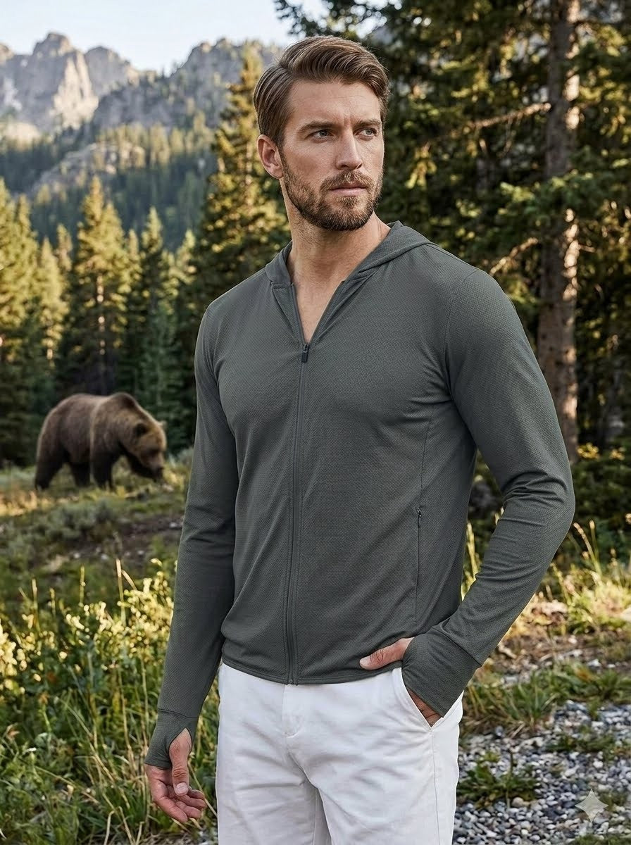 Man wearing a gray long-sleeve shirt in a forest with a bear in the background Biggreenbear.com