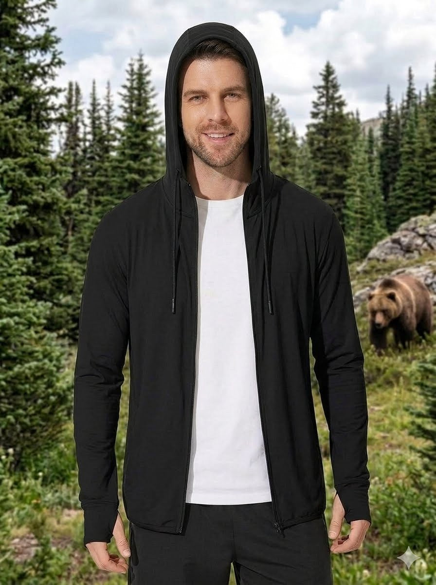 Man wearing a black hoodie with a bear in the background
