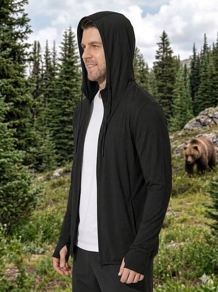 Person wearing a black hoodie with a bear in the background