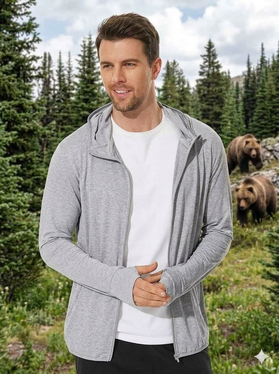 Man wearing a gray zip-up hoodie with bears in the background Big Green Bear