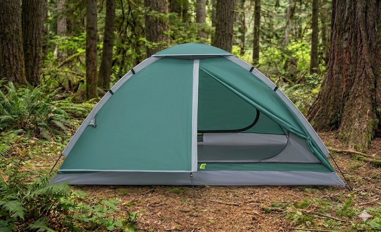 Green camping tent in a forest setting