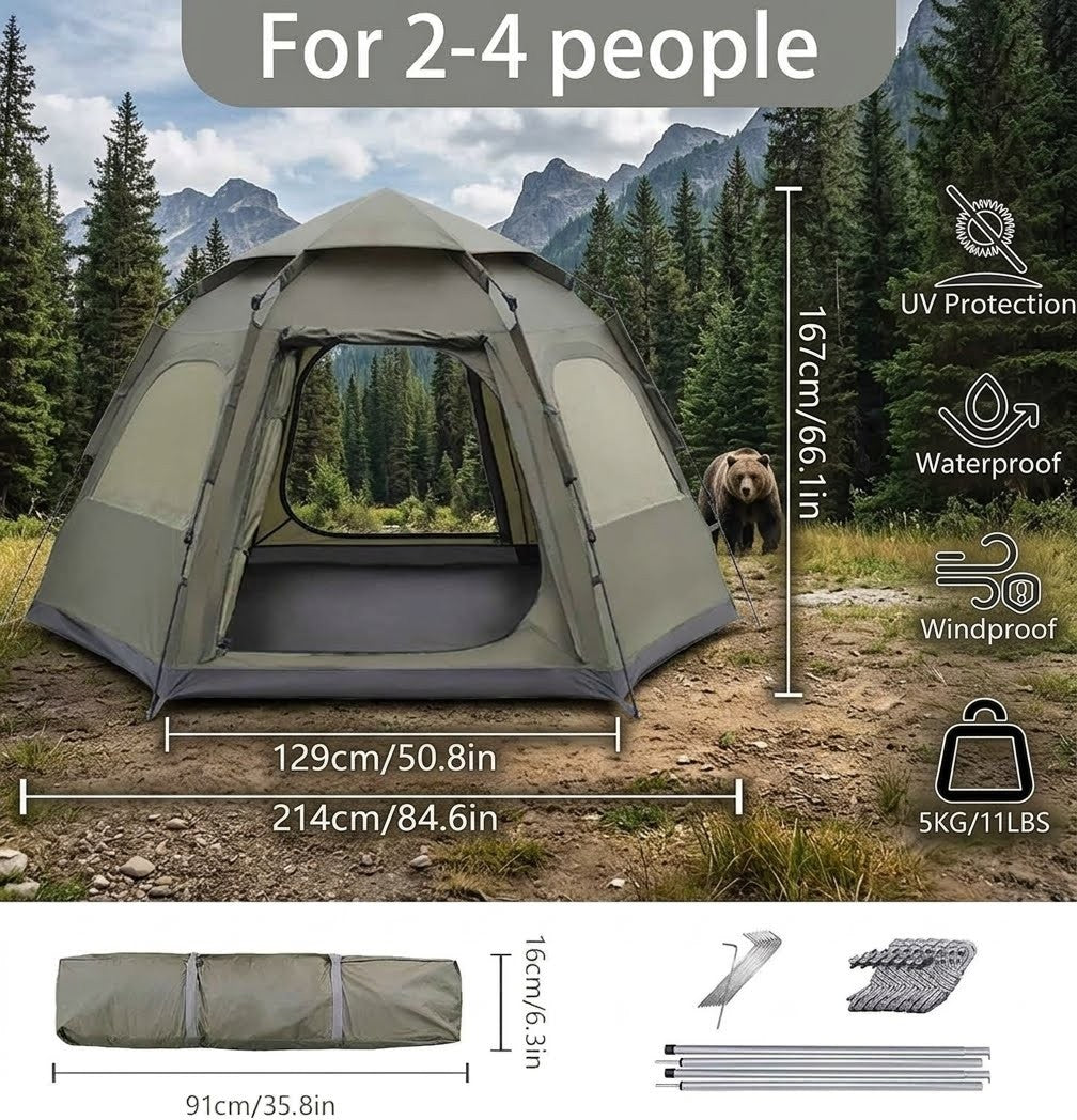 Camping tent with bear in the background, surrounded by trees and mountains.