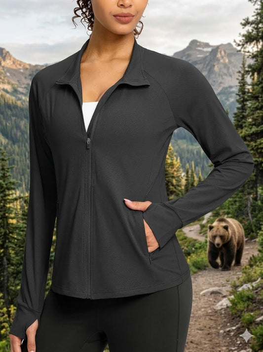 Person wearing a black jacket with a bear and mountainous landscape in the background big green bear