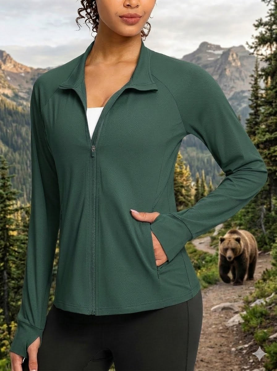 Person wearing a green jacket with a bear and mountainous landscape in the background big green bear