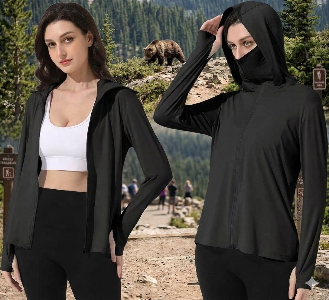 Woman wearing a black hoodie with a bear in the background big green bear