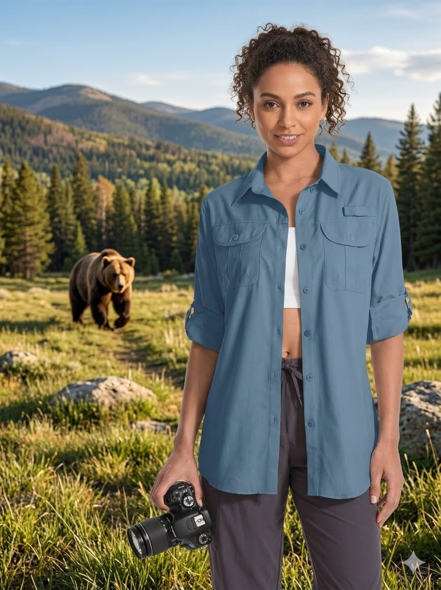 Woman in a blue shirt standing in a forest with a bear in the background big green bear