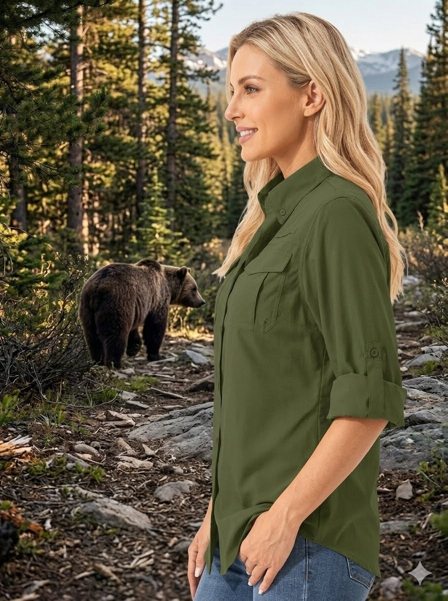 Woman in a green shirt standing in a forest with a bear nearby big green bear