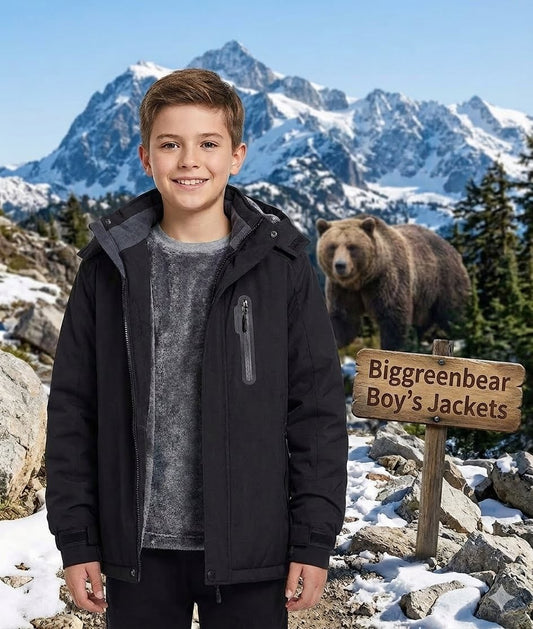 Boy standing in front of a mountainous landscape with a bear and 'Biggreenbear Boy's Jackets' sign.