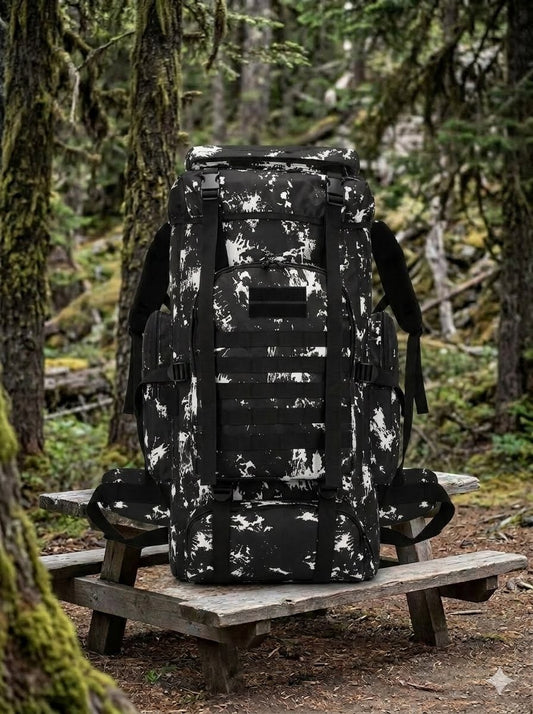 Black and white camouflage backpack on a wooden bench in a forest setting