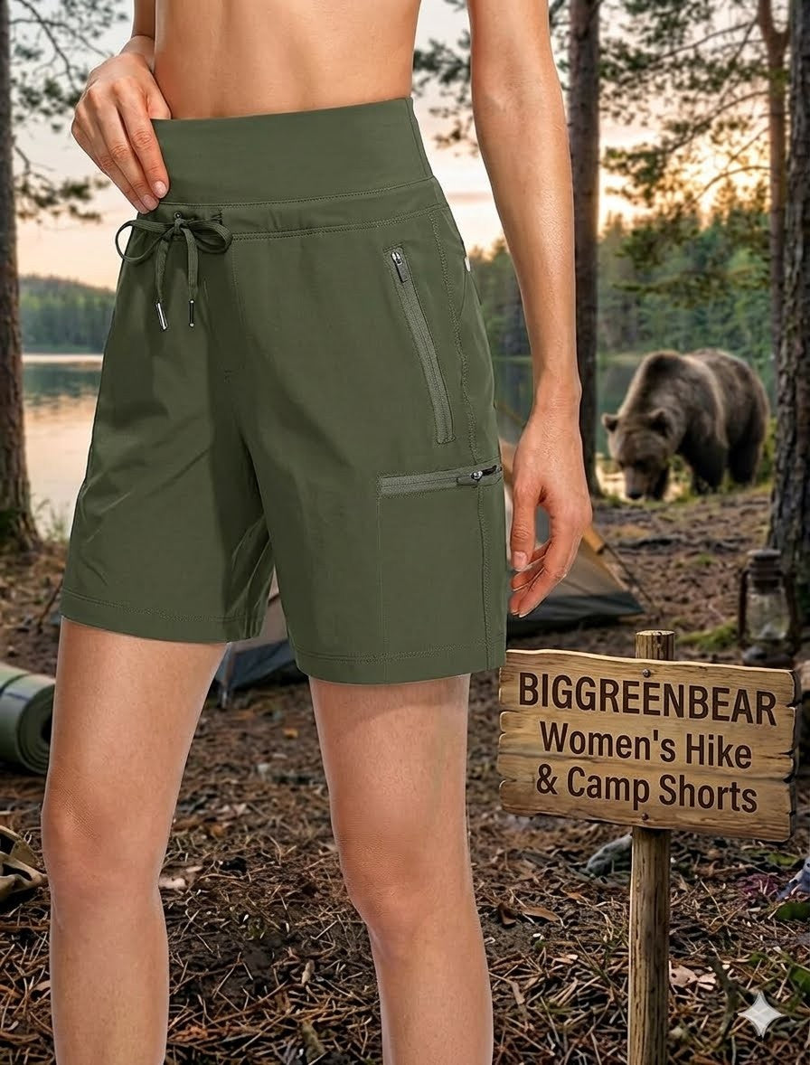 Person wearing green hiking shorts with a bear and camping gear in the background, featuring Biggreenbear branding.