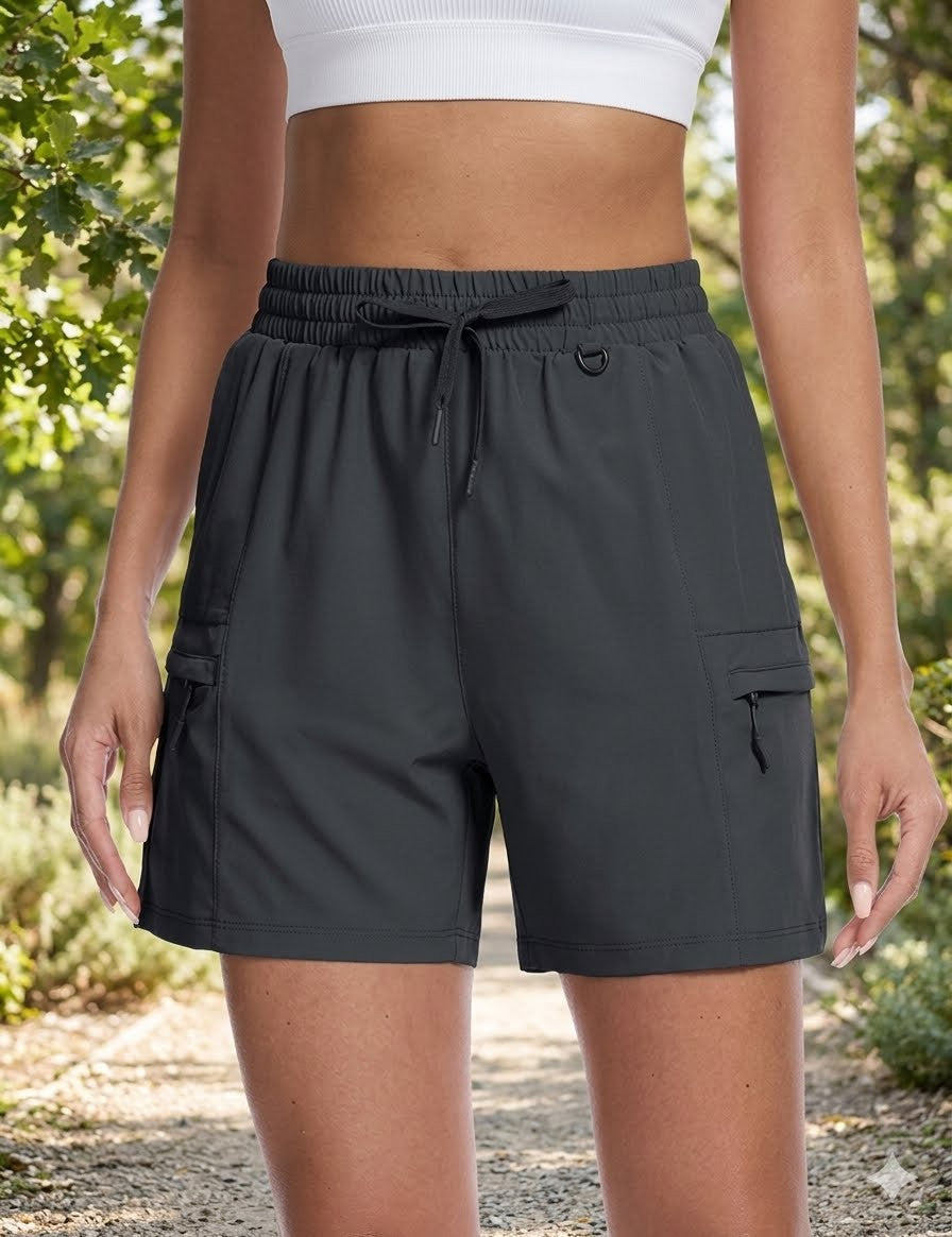 Person wearing black shorts with a blurred natural background