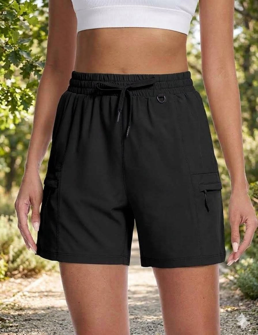 Person wearing black cargo shorts with a blurred natural background big green bear