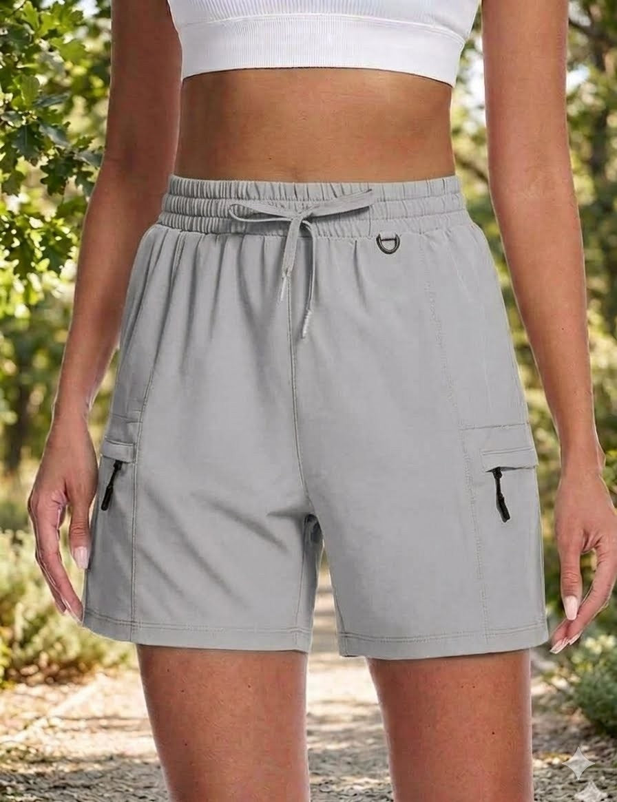 Person wearing gray cargo shorts with a blurred natural background big green bear