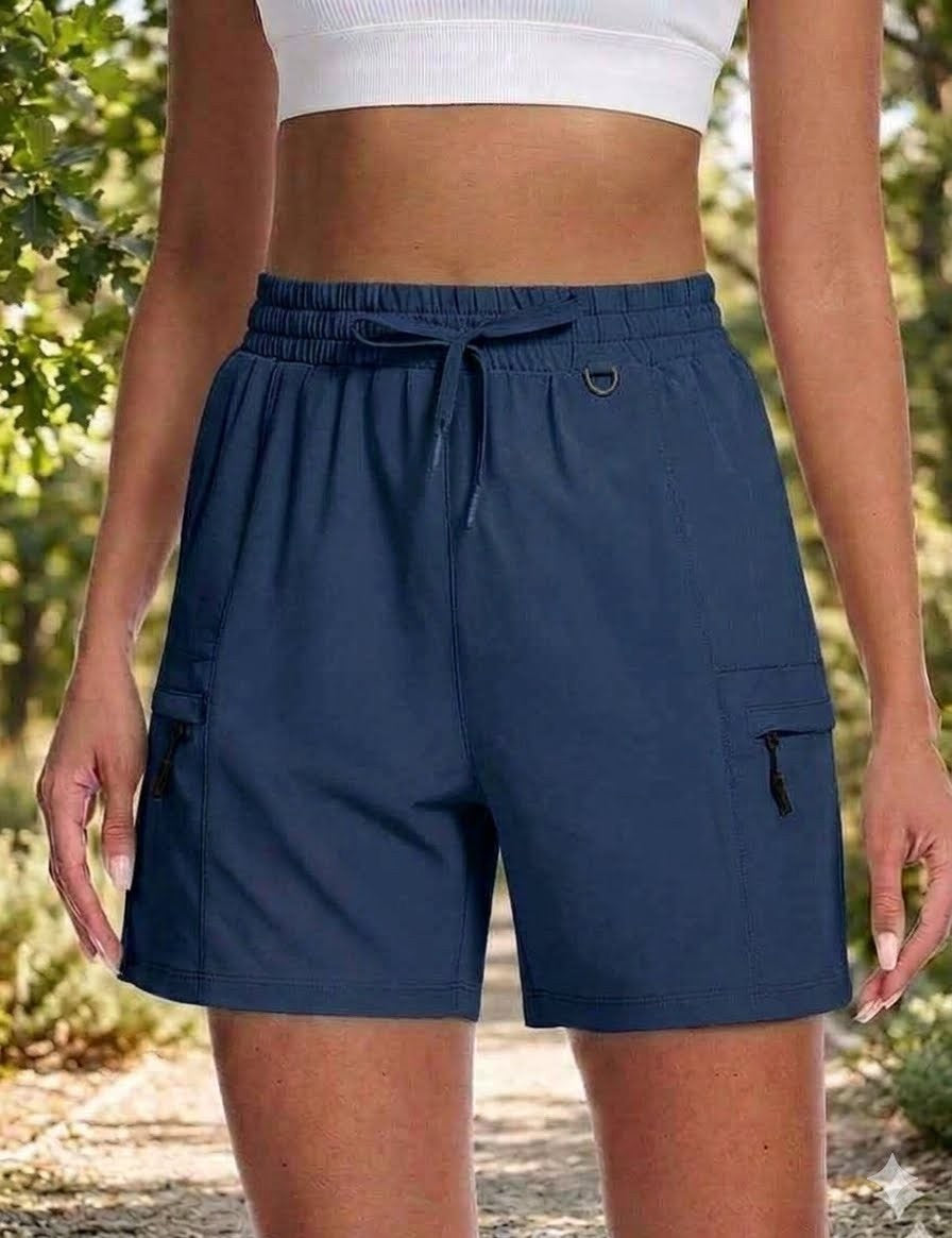 Person wearing navy shorts with a blurred natural background big green bear