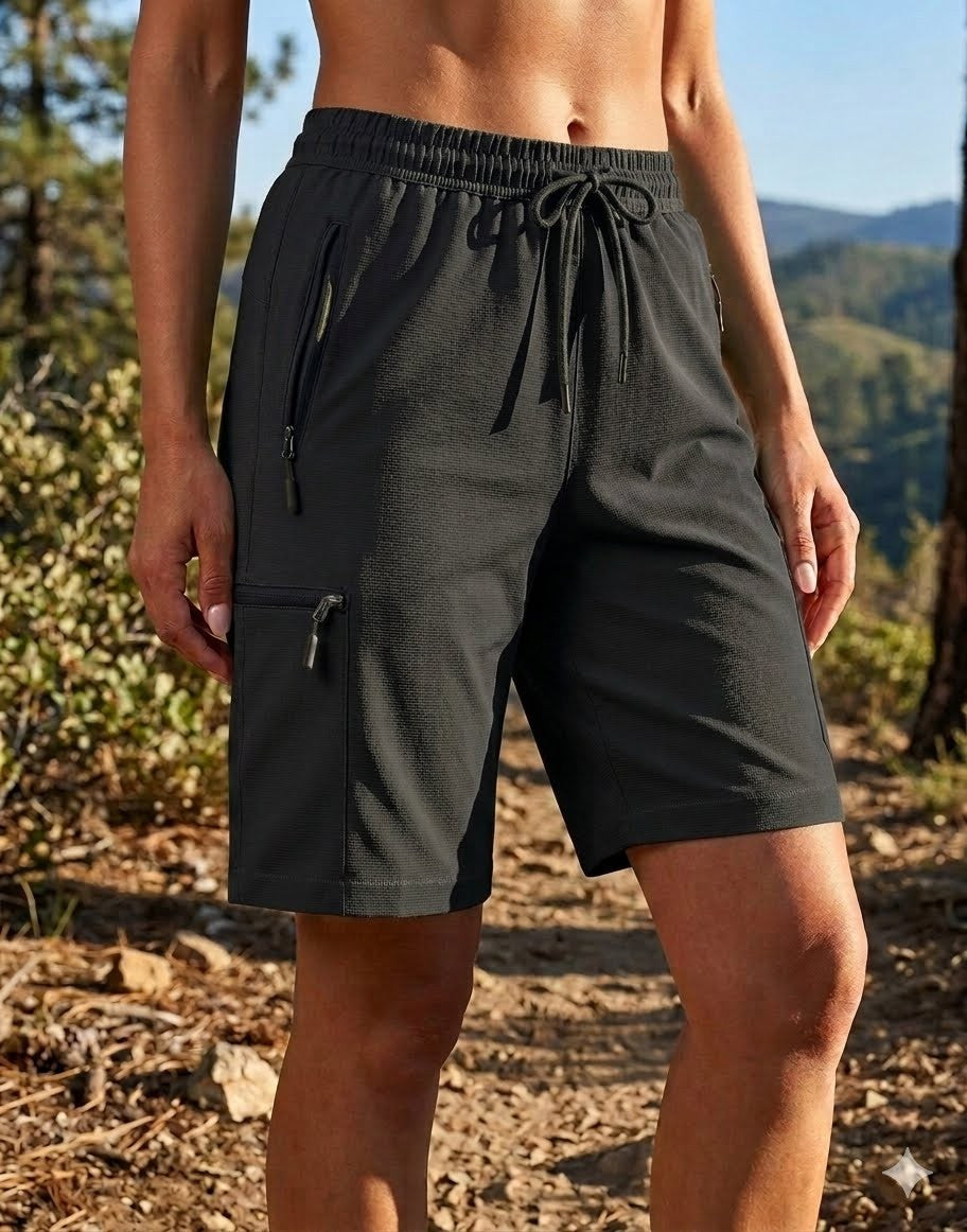 Person wearing black shorts in a natural setting with trees and mountains. big green bear