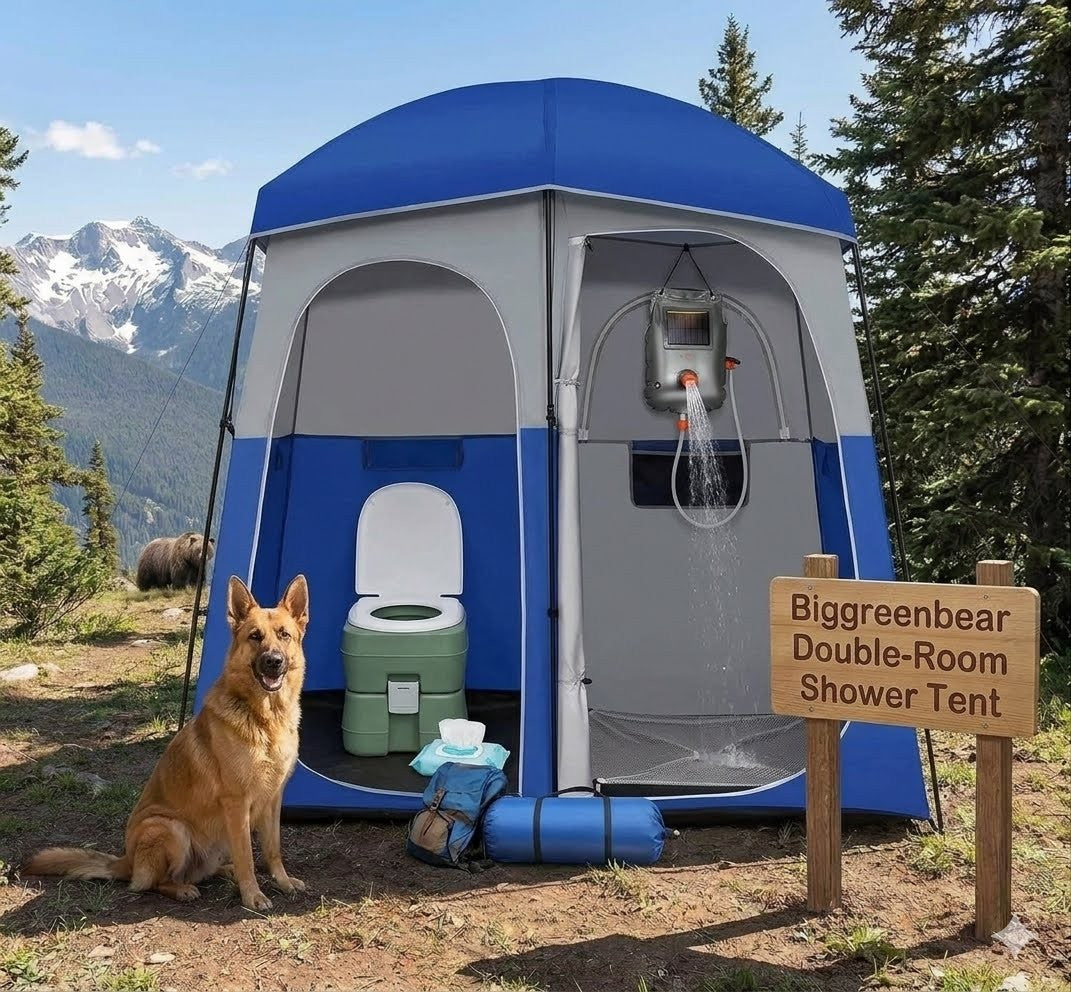 Blue and gray shower tent with toilet and shower setup in a natural setting with mountains and trees.