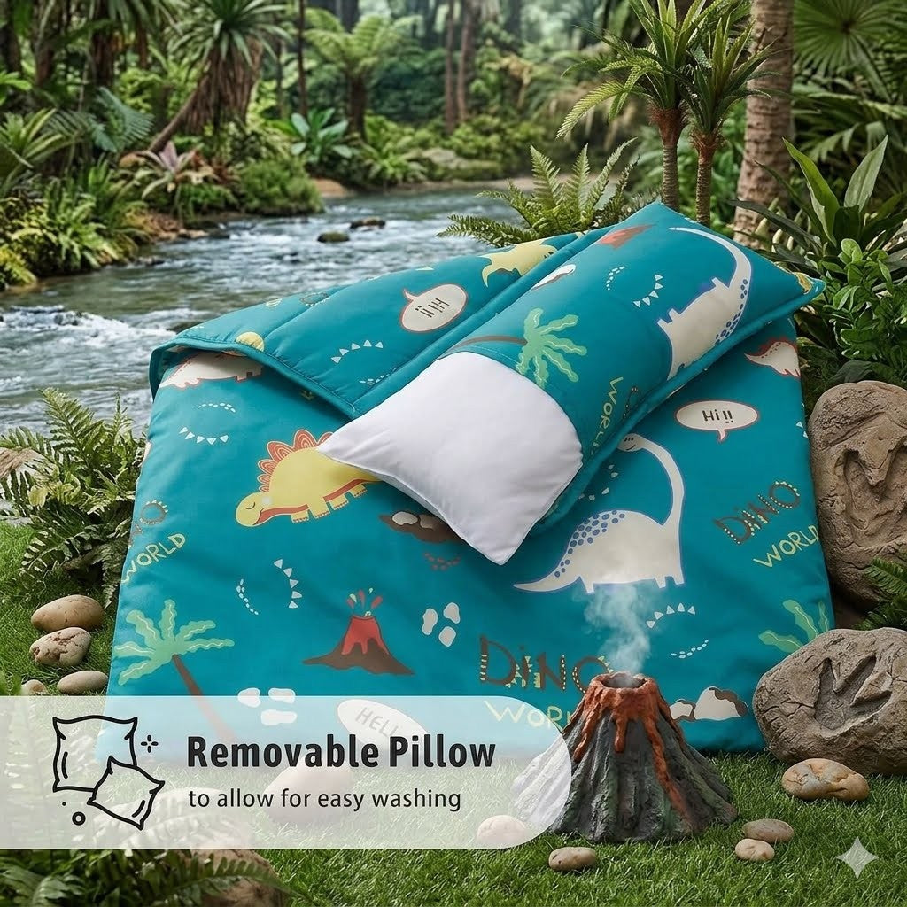 A close-up view of a teal dinosaur print toddler nap mat showing a white plush removable pillow being slid out of its fabric sleeve pocket for easy washing.