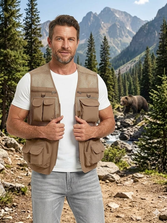 Big Green Bear tan mesh multi pocket fishing vest worn by man in forest with river background