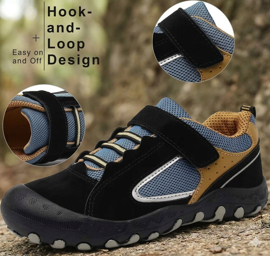 A children's outdoor shoe shown on a forest path with two circular inset close-ups highlighting the hook-and-loop strap design. The shoe has a black suede and mesh upper with blue panels, tan accents, white trim, and a dark sole with white circular details.