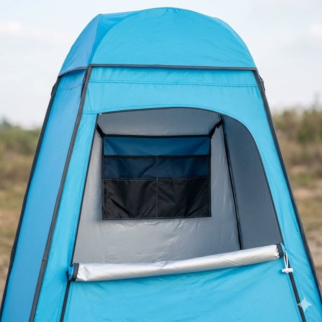 A bright blue pop-up outdoor shower tent with a window and mesh door, shown set up in an outdoor field.