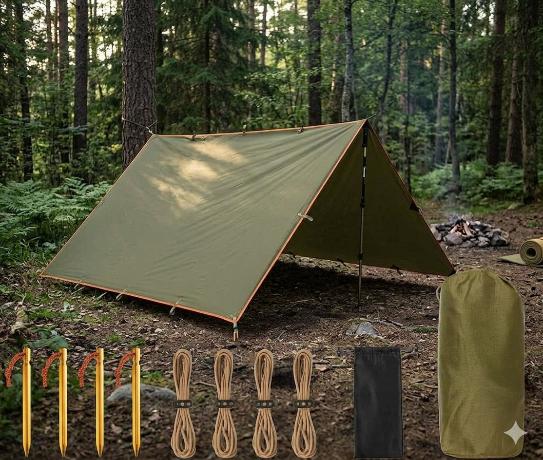 An olive green tarp-style camping shelter pitched in a forest, with tent stakes, rope, a black bag, and the shelter packed in a drawstring sack shown along the bottom against a wooded outdoor background.