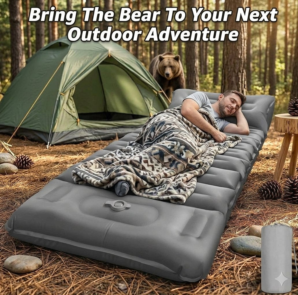 A man sleeps on a gray inflatable camping sleeping pad in a forest campsite next to a green tent, with a bear visible in the trees behind. Large text at the top reads 'Bring The Bear To Your Next Outdoor Adventure'.