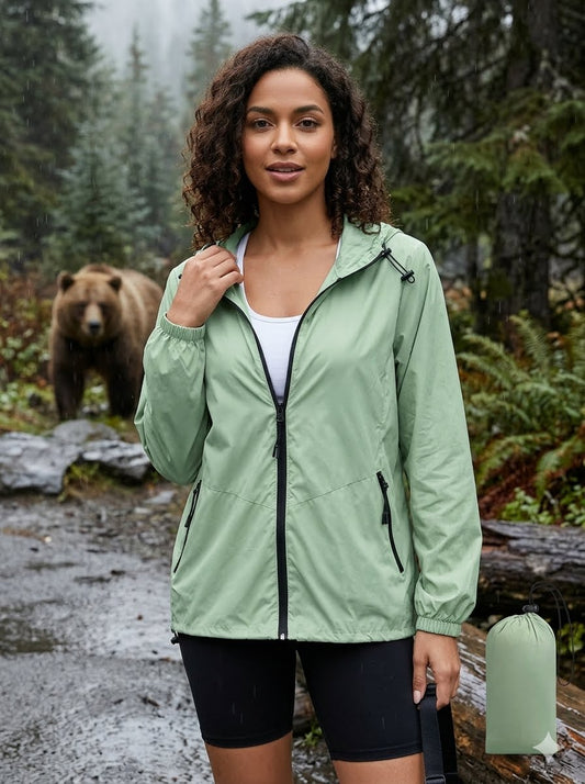Woman in a green jacket standing in a forest with a bear in the background Big Green Bear