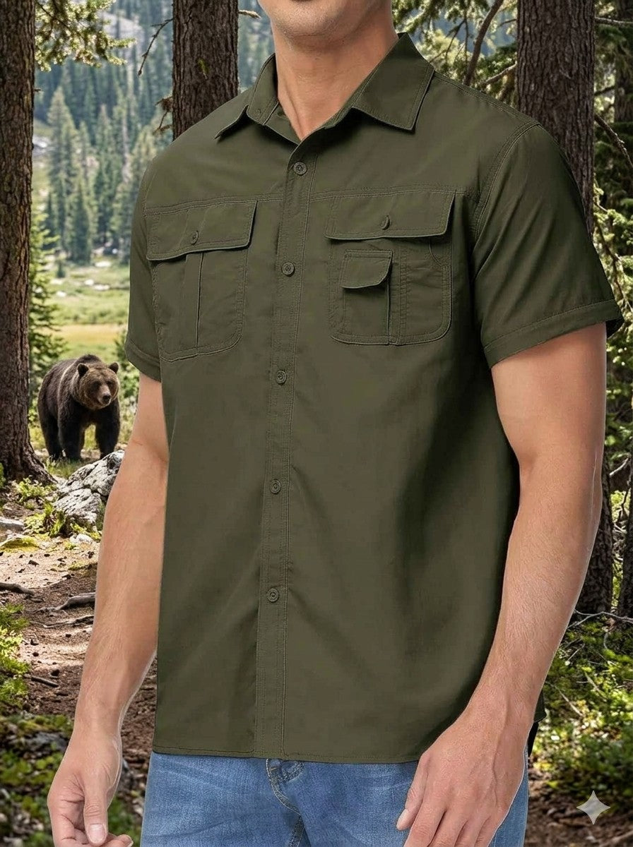 Person wearing an olive green short-sleeve shirt with a bear in the background