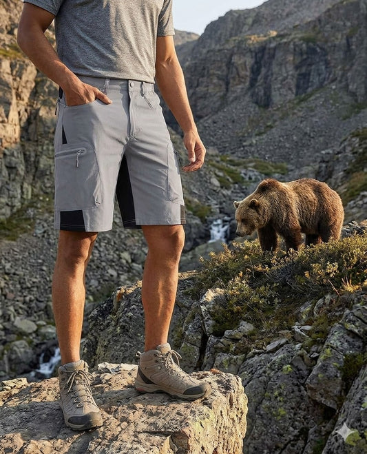 Men's black 10-inch hiking cargo shorts with five secure pockets and water-resistant fabric on a light wood background.